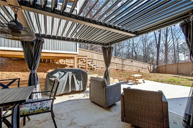 a view of a porch with furniture and floor to ceiling window