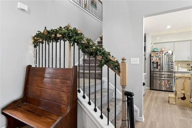 a view of entryway and hall with wooden floor