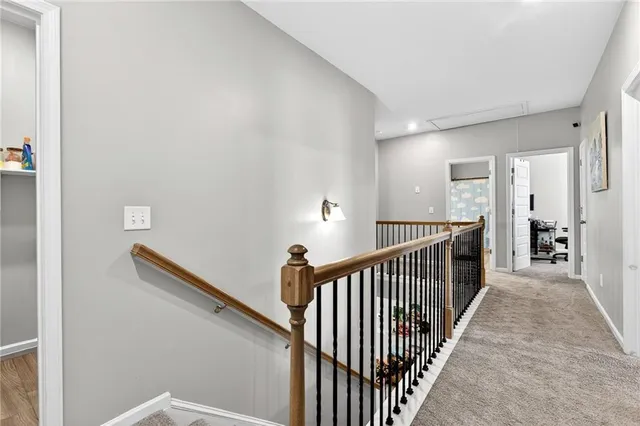 a view of a hallway with wooden floor and stairs
