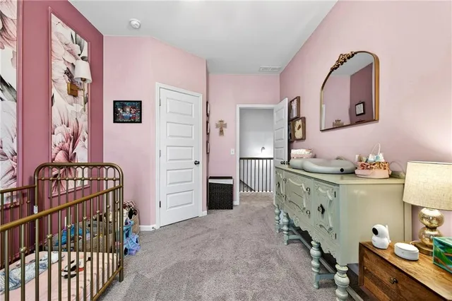 a room with a baby crib furniture and a dresser