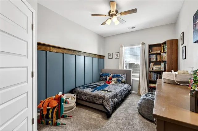 a bedroom with bed and a chandelier