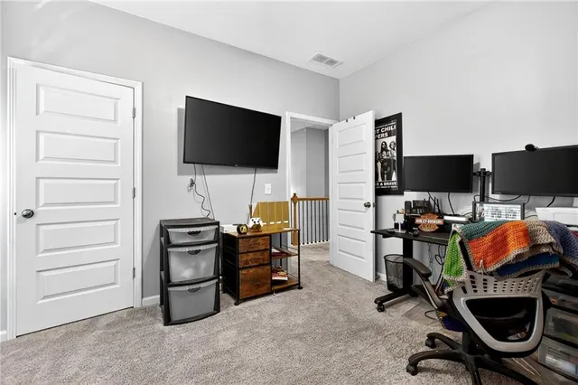 a view of a livingroom with furniture and a flat screen tv