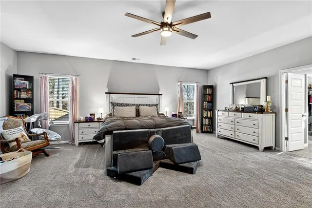 a bedroom with furniture and a large window