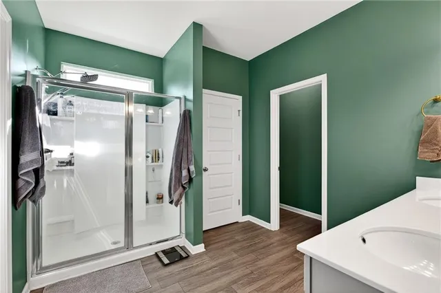 a bathroom with a shower and a mirror