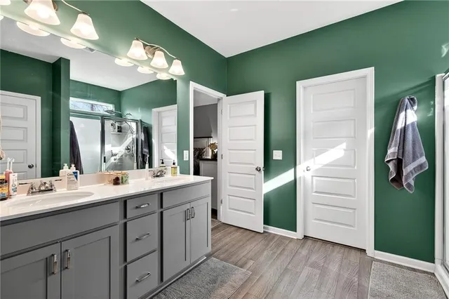 a bathroom with a double vanity sink a and a mirror