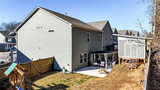 a view of a house with backyard and sitting area