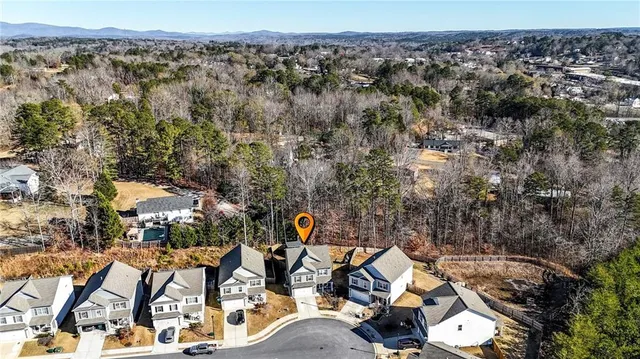 an aerial view of a house with a yard