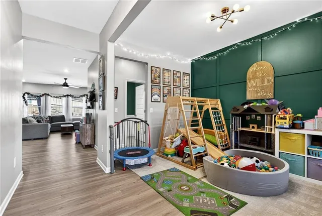 a living room filled with furniture and a wooden floor