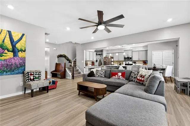 a living room with furniture and a wooden floor