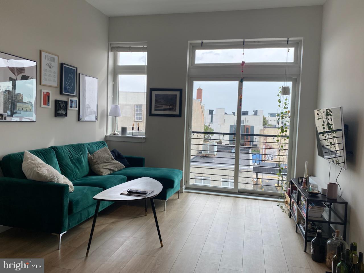 18 West Girard Avenue, Unit 3 Philadelphia, PA 19123 - Photo 1 of 17 a living room with furniture and a floor to ceiling window