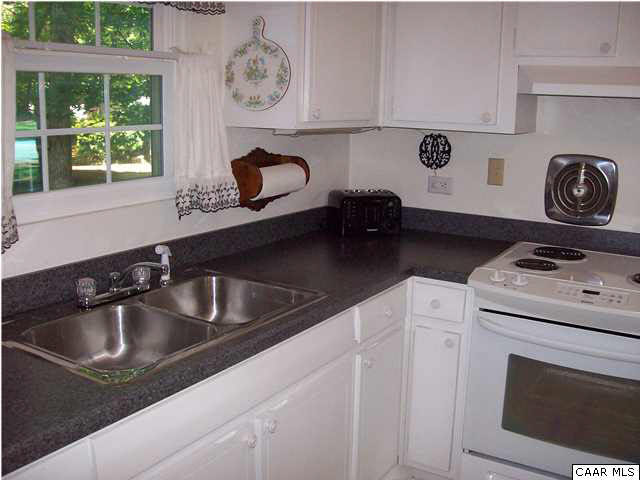 615 Shamrock Road Charlottesville, VA 22903 - Photo 8 of 20 a kitchen with a white stove top oven and sink