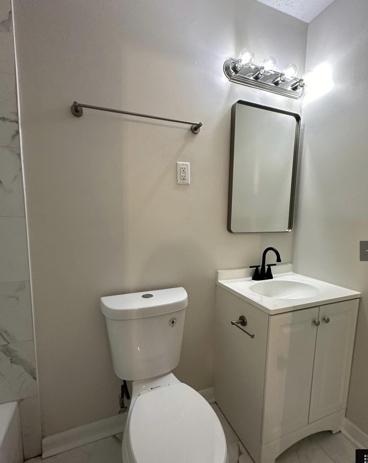 3865 Elliston Road Memphis, TN 38111 - Photo 9 of 11 a bathroom with a toilet sink and mirror