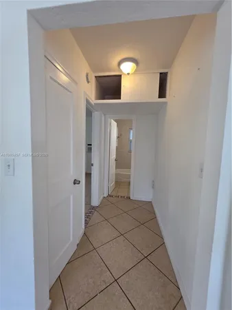 a view of a hallway to rooms