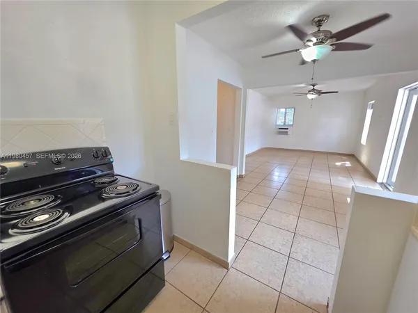 a view of an empty room with windows and cabinet