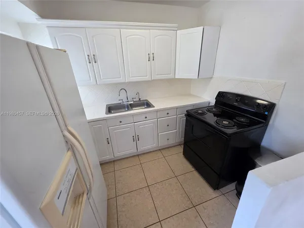 a kitchen with a sink a stove and refrigerator