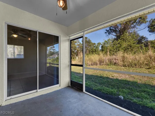 a view of a floor to ceiling window and a yard