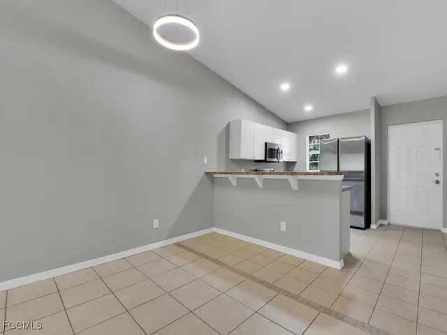 a kitchen with cabinets and window
