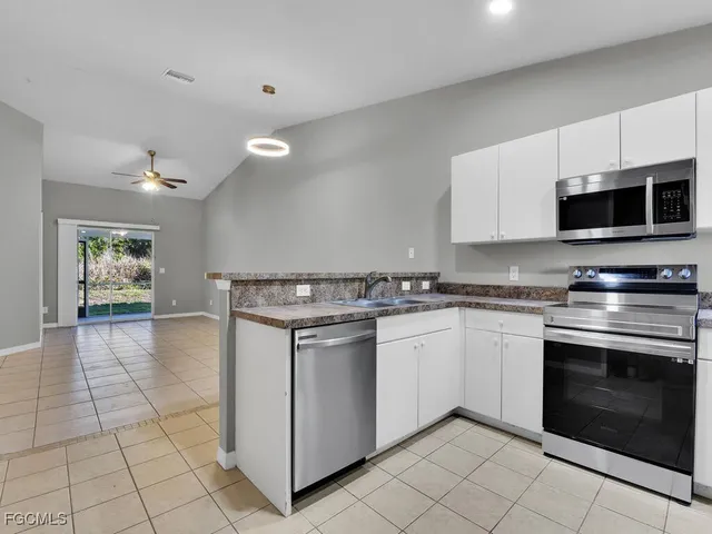 a kitchen with stainless steel appliances a refrigerator stove and microwave