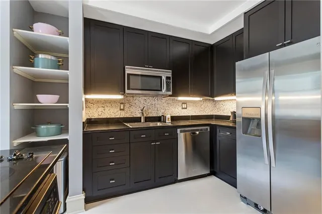 a kitchen with stainless steel appliances granite countertop a stove and a refrigerator