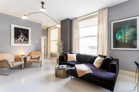 a living room with furniture and a chair