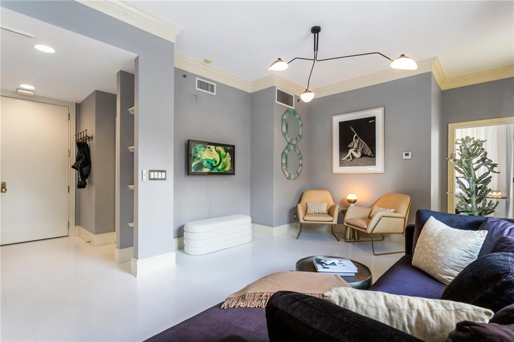 57 Forsyth Street Northwest, Unit 5F Atlanta, GA 30303 - Photo 21 of 44 a bedroom with furniture and a chandelier