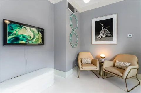 a bed sitting in a spacious bedroom next to a window