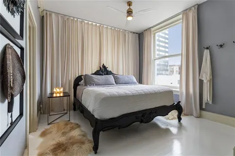 a large bed sitting in a bedroom next to a window