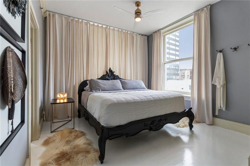 57 Forsyth Street Northwest, Unit 5F Atlanta, GA 30303 - Photo 27 of 44 a bed sitting in a spacious bedroom next to a window