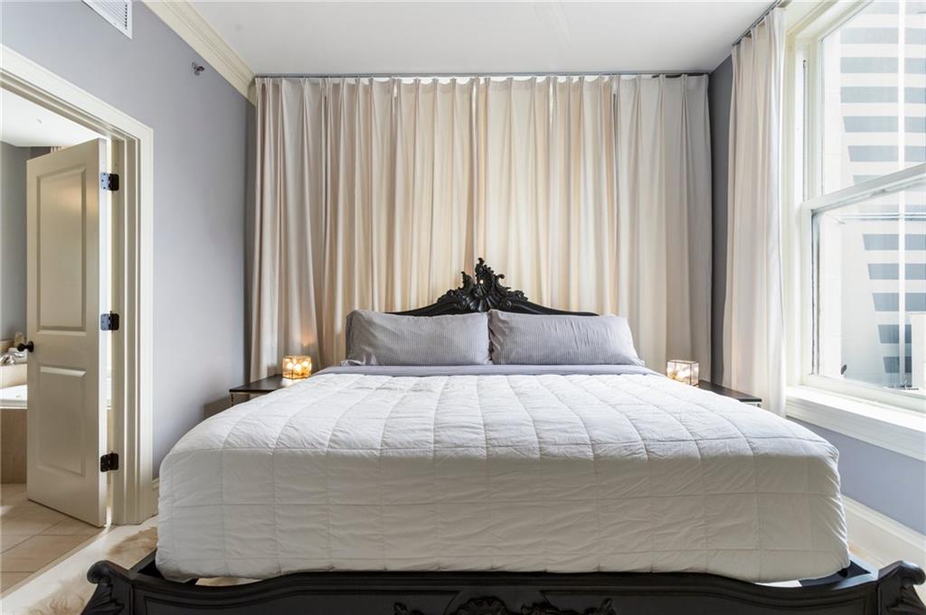 57 Forsyth Street Northwest, Unit 5F Atlanta, GA 30303 - Photo 29 of 44 a large bed sitting in a bedroom next to a window