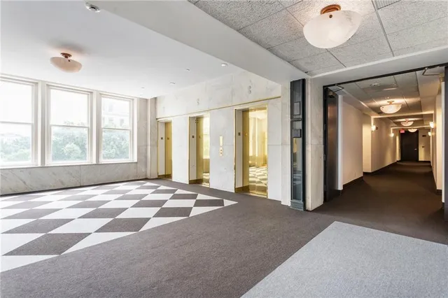 a living room with furniture large window and flat screen tv