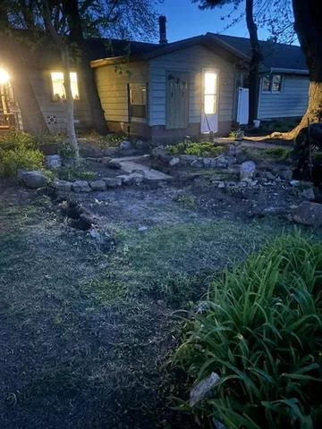 a view of a backyard with plants and a patio