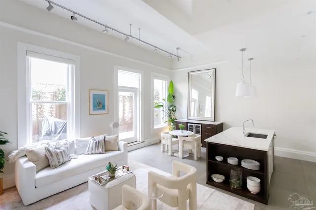 a living room with furniture and floor to ceiling windows