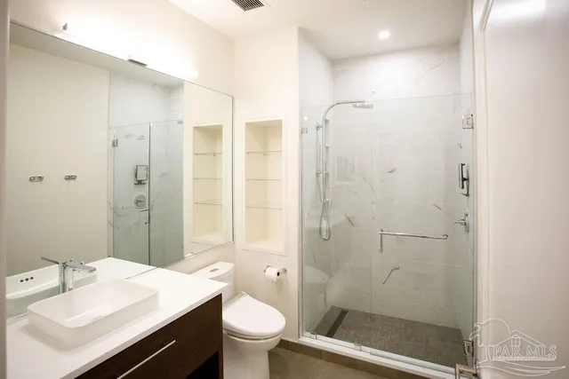 a room with a window and a dresser