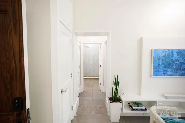 a front view of a building with street view and trees