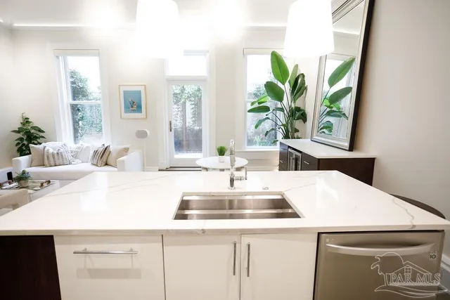a kitchen with a table chairs stove and kitchen view