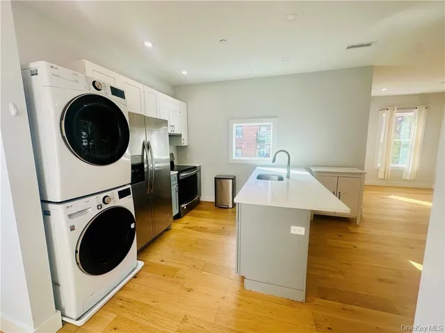 a view of a kitchen with a washer and dryer