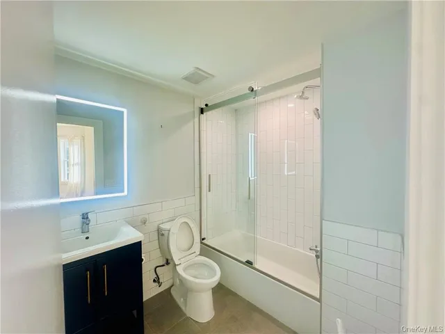 a bathroom with a double vanity sink toilet and shower
