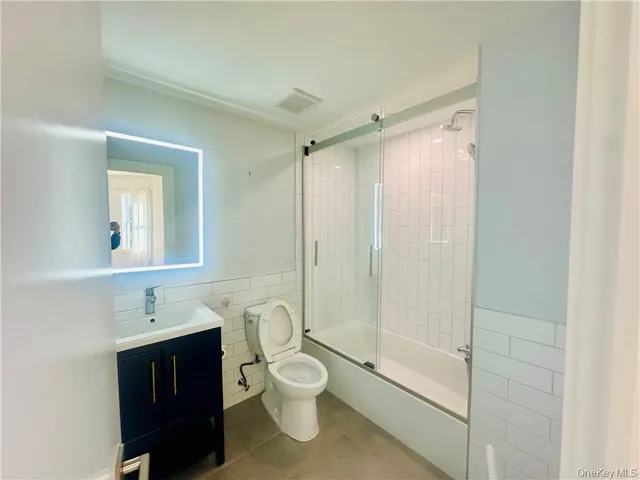 a bathroom with a toilet a sink and a shower