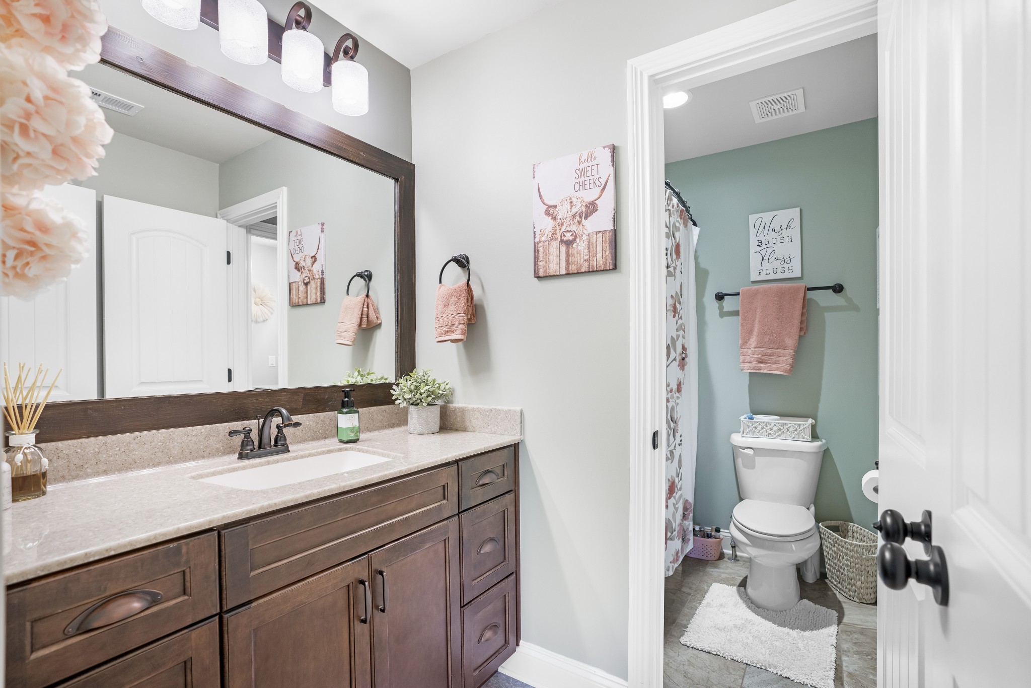5065 Pickering Road Clarksville, TN 37043 - Photo 23 of 35 a bathroom with a toilet sink and mirror
