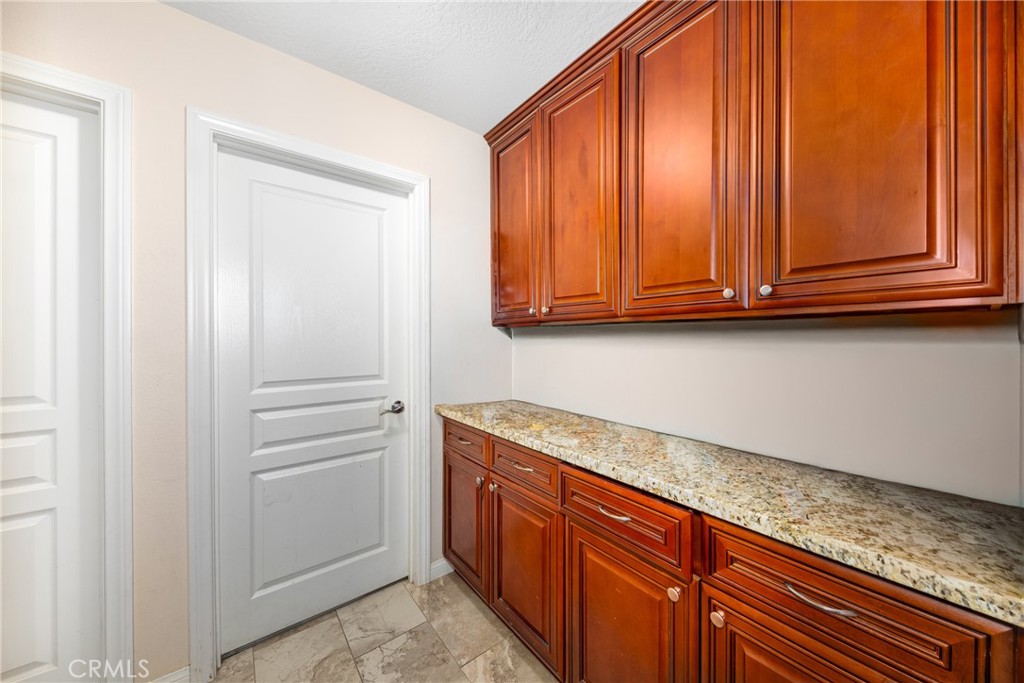 14632 Maricopa Road Victorville, CA 92392 - Photo 11 of 43 a view of cabinets with wooden floor