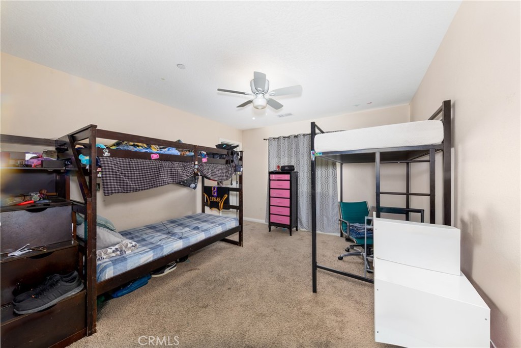 14632 Maricopa Road Victorville, CA 92392 - Photo 14 of 43 a bedroom with furniture and a ceiling fan