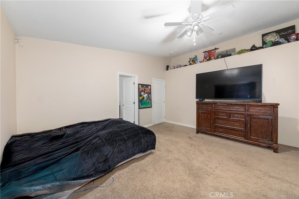 14632 Maricopa Road Victorville, CA 92392 - Photo 17 of 43 a bedroom with a bed and a flat screen tv