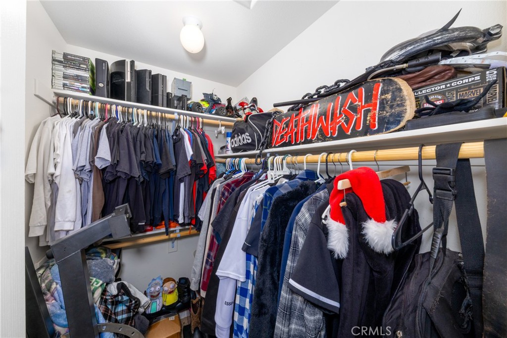 14632 Maricopa Road Victorville, CA 92392 - Photo 18 of 43 a view of walk in closet with clothes and shoes