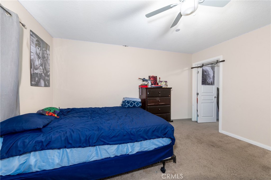 14632 Maricopa Road Victorville, CA 92392 - Photo 21 of 43 a bedroom with a bed and a closet