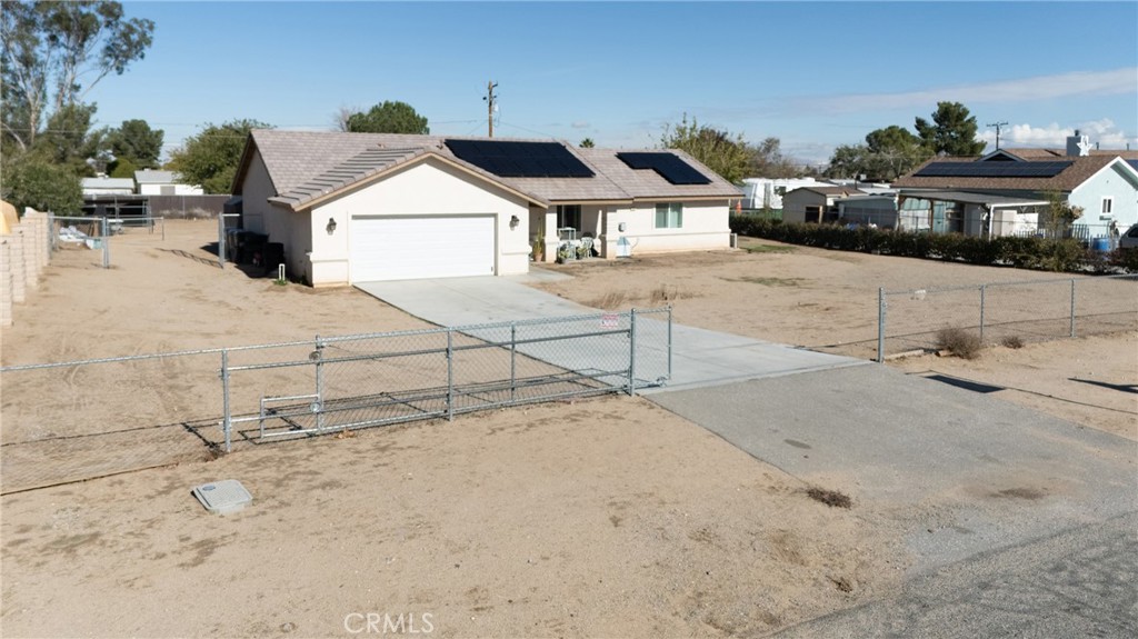 14632 Maricopa Road Victorville, CA 92392 - Photo 25 of 43 a house with a bench in front of it
