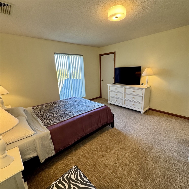 915 Hathaway Road, Unit 105 New Bedford, MA 02740 - Photo 13 of 24 a bedroom with a bed and couch