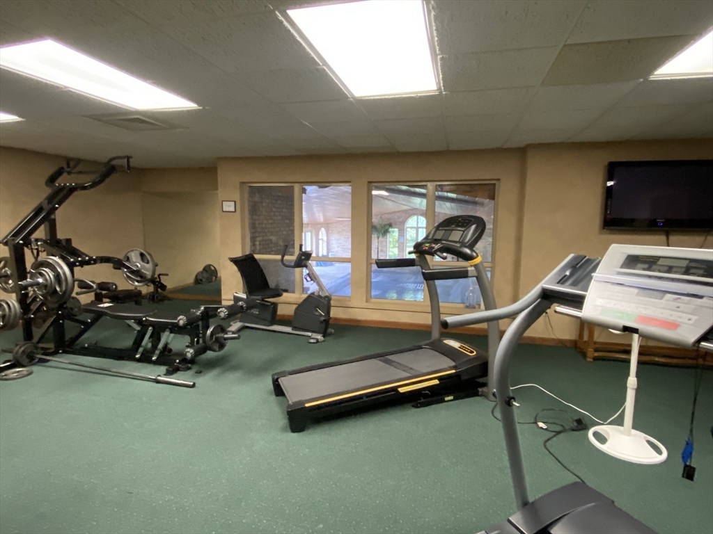 915 Hathaway Road, Unit 105 New Bedford, MA 02740 - Photo 23 of 24 a room with gym equipment and a flat screen tv