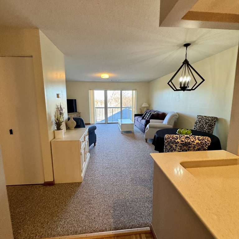 915 Hathaway Road, Unit 105 New Bedford, MA 02740 - Photo 7 of 24 a bed room with furniture and a chandelier