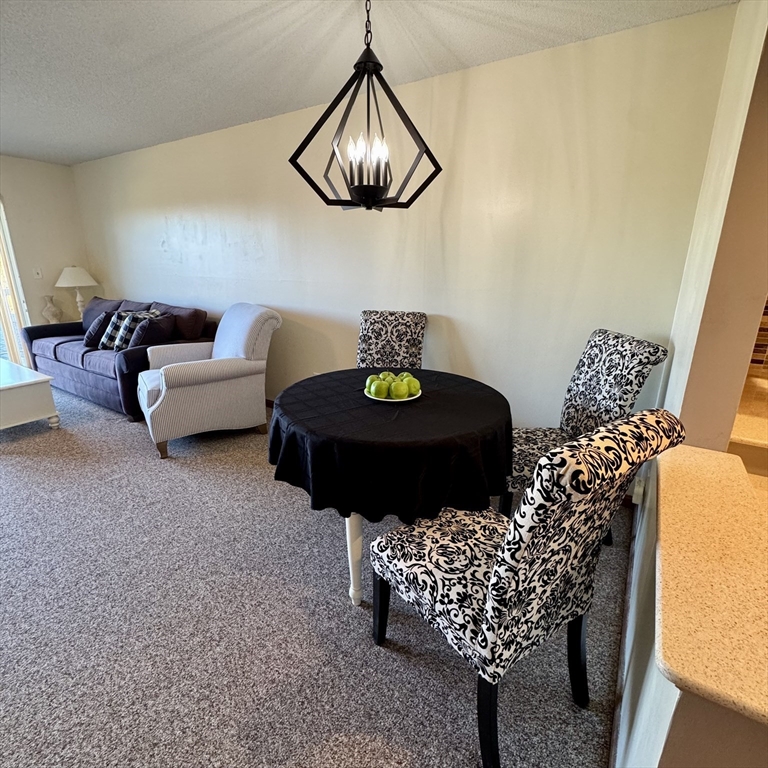 915 Hathaway Road, Unit 105 New Bedford, MA 02740 - Photo 8 of 24 a living room with furniture and a rug