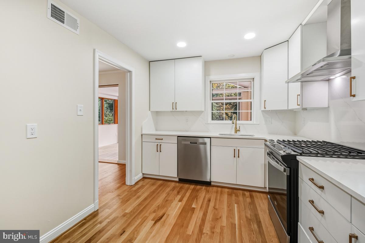 1203 Brantford Avenue Silver Spring, MD 20904 - Photo 11 of 32 a kitchen with a sink window and cabinets